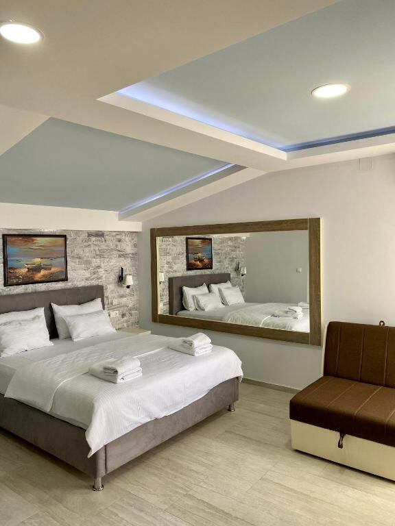 Spacious room with seating area and large mirror