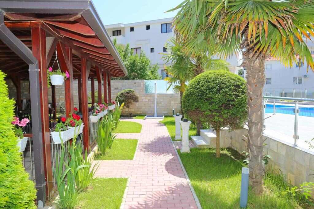 Garden path and shaded terrace in the property grounds